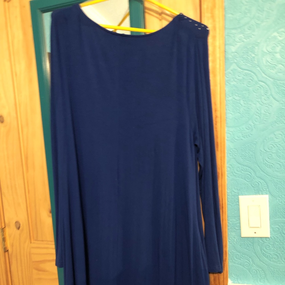 Long sleeve dress . Has pockets and flair on the bottom .
